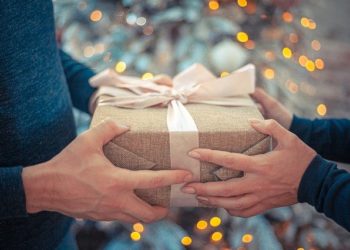 Handing over gift by girl to boyfriend