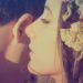 A girlfriend whispering to her boy friend